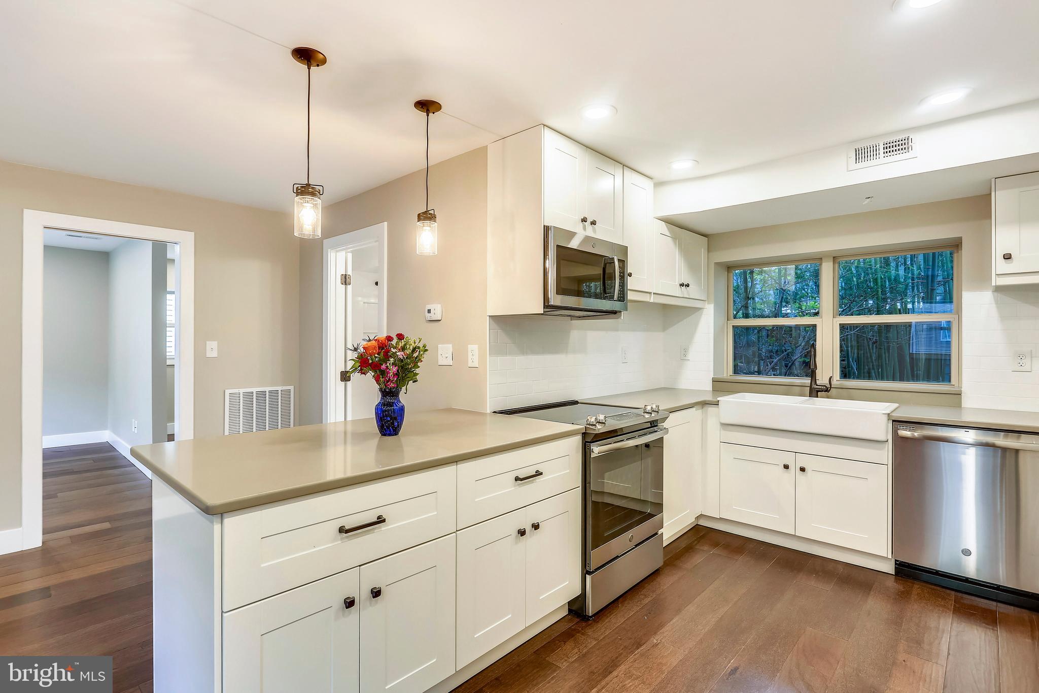 6 Circle Circle Washington Grove, MD 20880 - Photo 11 of 45 a kitchen with stainless steel appliances white cabinets and wooden floors