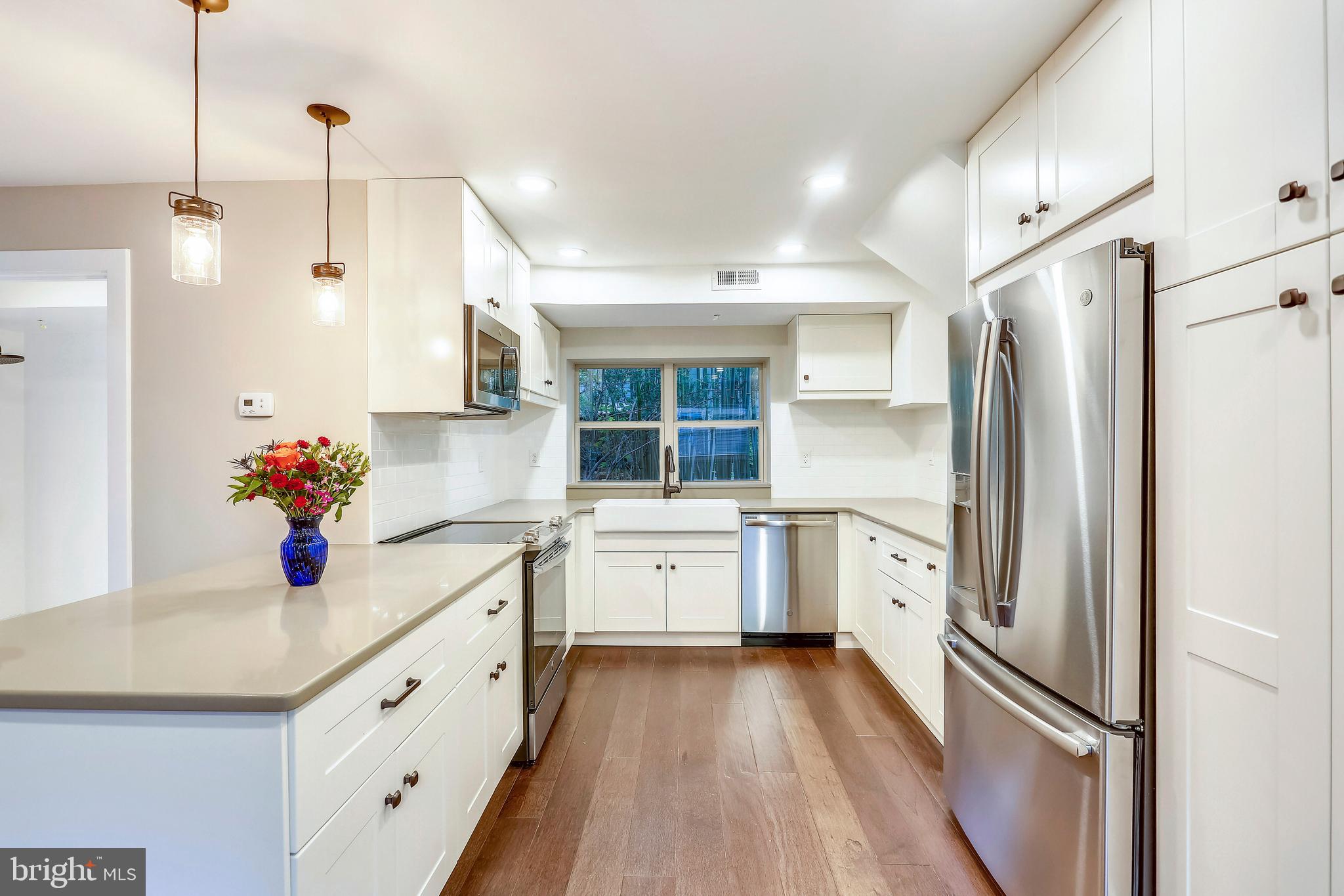 6 Circle Circle Washington Grove, MD 20880 - Photo 13 of 45 a kitchen with a refrigerator and white cabinets