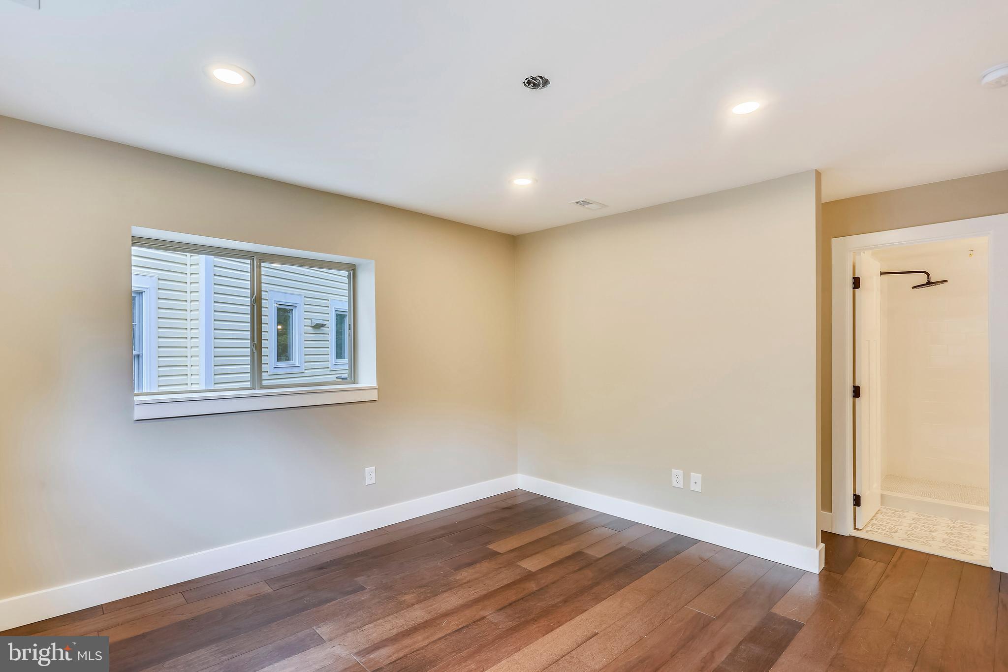 6 Circle Circle Washington Grove, MD 20880 - Photo 20 of 45 a view of an empty room with wooden floor and a window