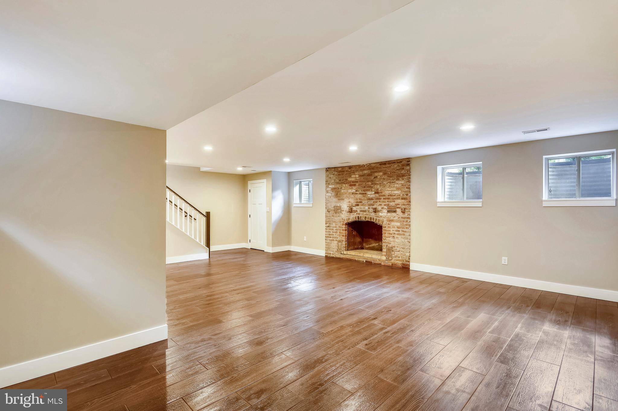 6 Circle Circle Washington Grove, MD 20880 - Photo 37 of 45 a view of an empty room with wooden floor fireplace and a window