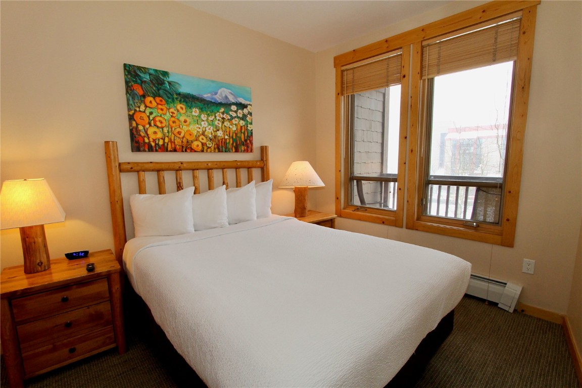 172 Copper Circle, Unit 301 Copper Mountain, CO 80443 - Photo 13 of 23 a large bed sitting in a bedroom next to a window