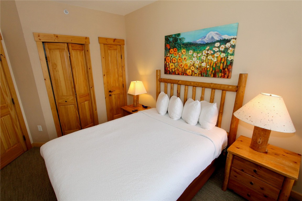 172 Copper Circle, Unit 301 Copper Mountain, CO 80443 - Photo 14 of 23 a bed sitting in a bedroom next to a window