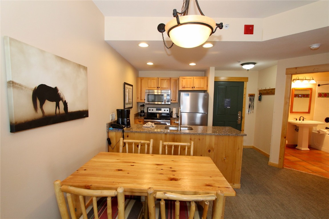 172 Copper Circle, Unit 301 Copper Mountain, CO 80443 - Photo 6 of 23 a large kitchen with a table and chairs