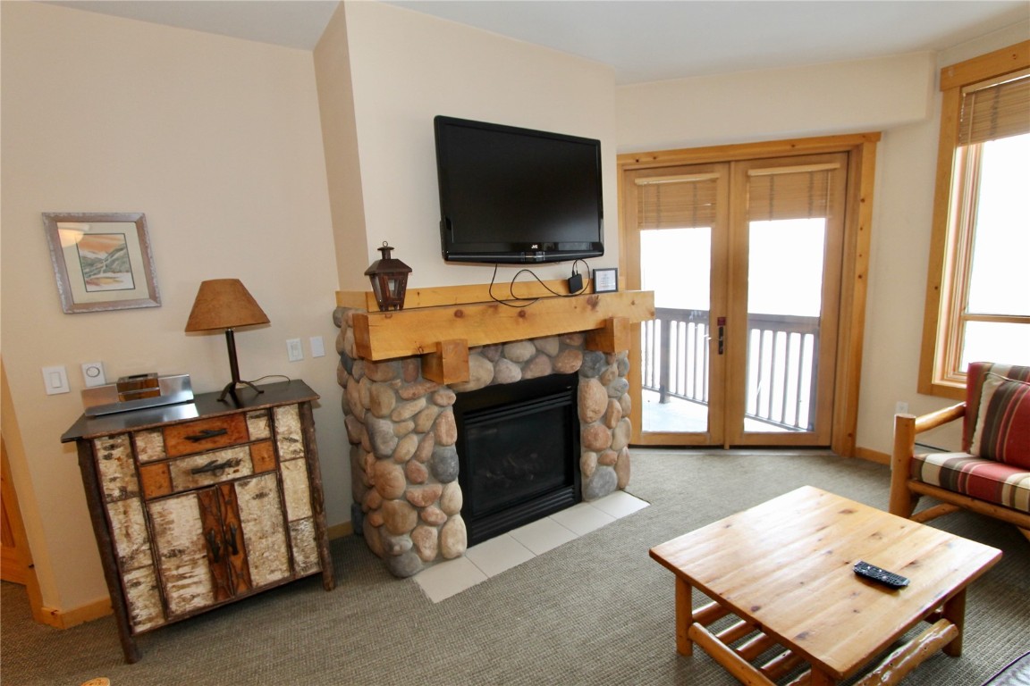 172 Copper Circle, Unit 301 Copper Mountain, CO 80443 - Photo 10 of 23 a living room with furniture a flat screen tv and a fireplace