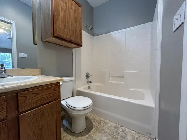 a bathroom with a sink a toilet and bathtub