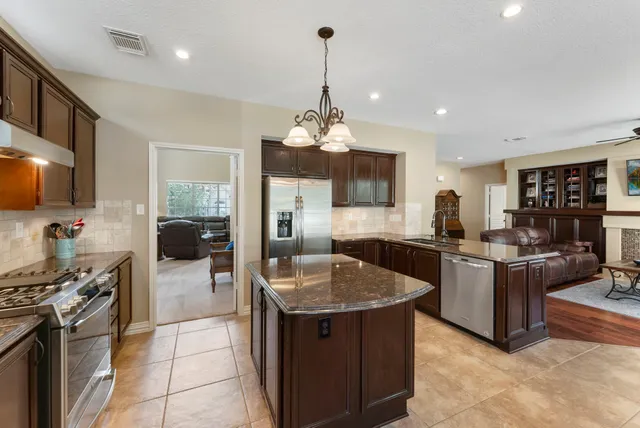a kitchen with stove and cabinets