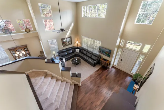 a view of a livingroom with furniture hardwood floor and a ceiling fan