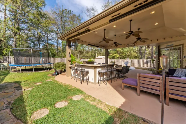 a view of a patio with a table chairs and a backyard