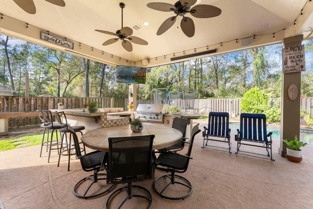 a dining room with furniture water view and a floor to ceiling window
