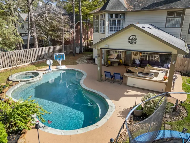 a view of a house with swimming pool and sitting area