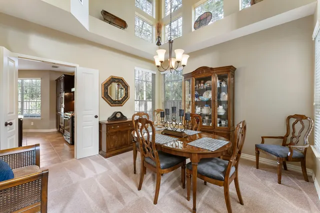 a view of a dining room with furniture and chandelier