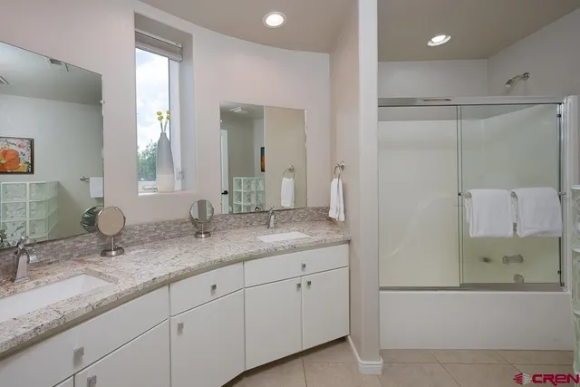 a bathroom with a granite countertop sink mirror and double