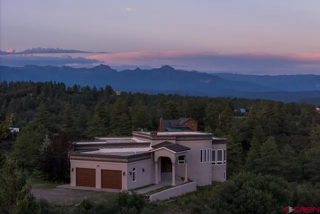a view of a big house with a mountain in the background