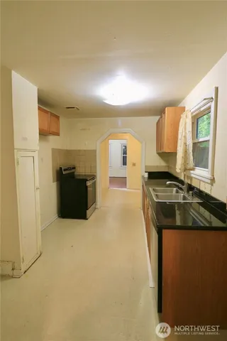 a kitchen with stainless steel appliances granite countertop a sink and a stove