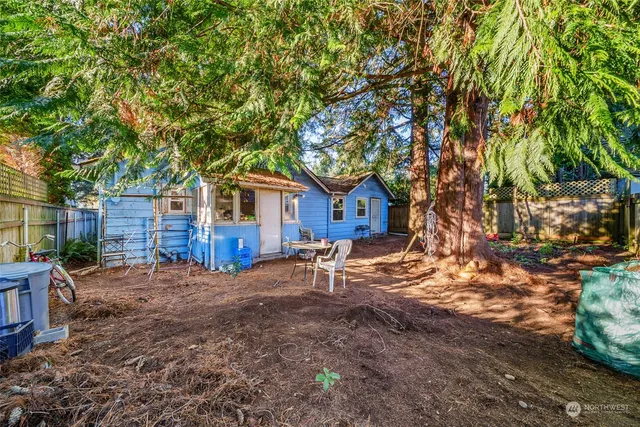 a wooden bench sitting in front of a house