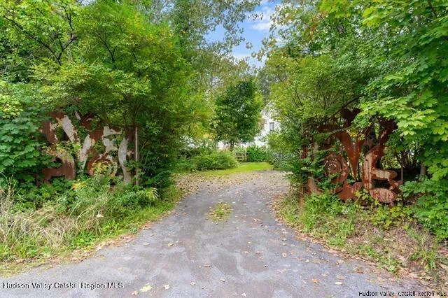 a view of a pathway with a tree