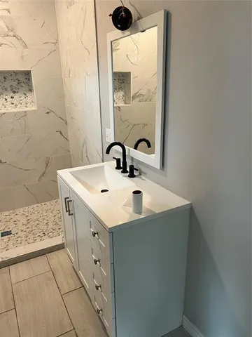 a bathroom with a sink a toilet and mirror