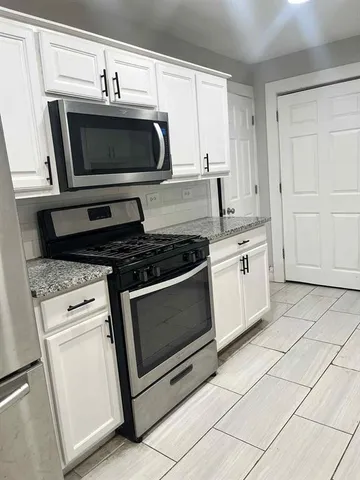 a kitchen with a stove and a microwave