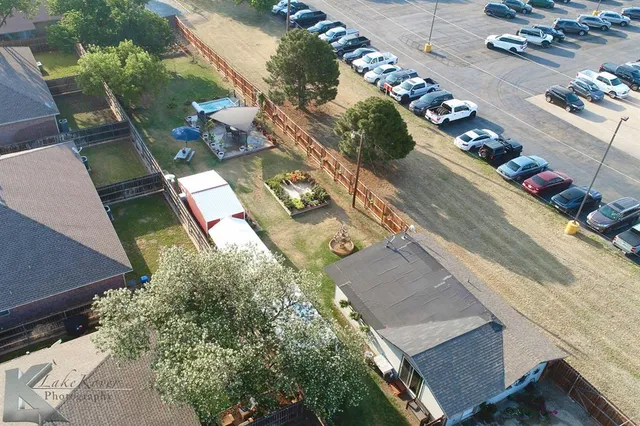 an aerial view of a house with yard swimming pool and outdoor seating