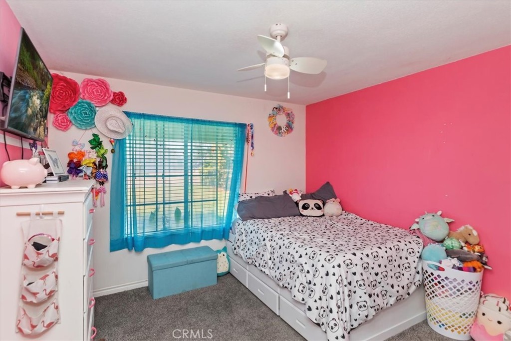 1441 Fifth Street Norco, CA 92860 - Photo 23 of 72 a bedroom with a bed and a chandelier