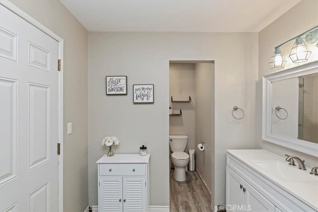 1441 Fifth Street Norco, CA 92860 - Photo 29 of 72 a spacious bathroom with a sink a toilet and a large mirror