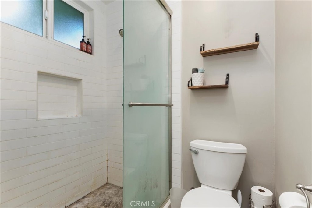 1441 Fifth Street Norco, CA 92860 - Photo 31 of 72 a white toilet sitting next to a bathroom sink