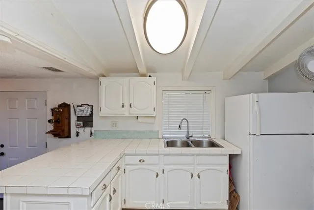 a view of a house with a yard and sitting area