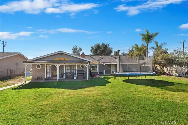 a view of a house with swimming pool and sitting area