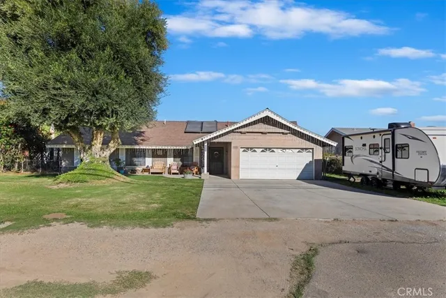 a view of a house with a yard and garage