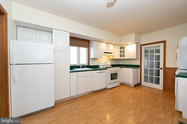a kitchen with stainless steel appliances a refrigerator sink and cabinets