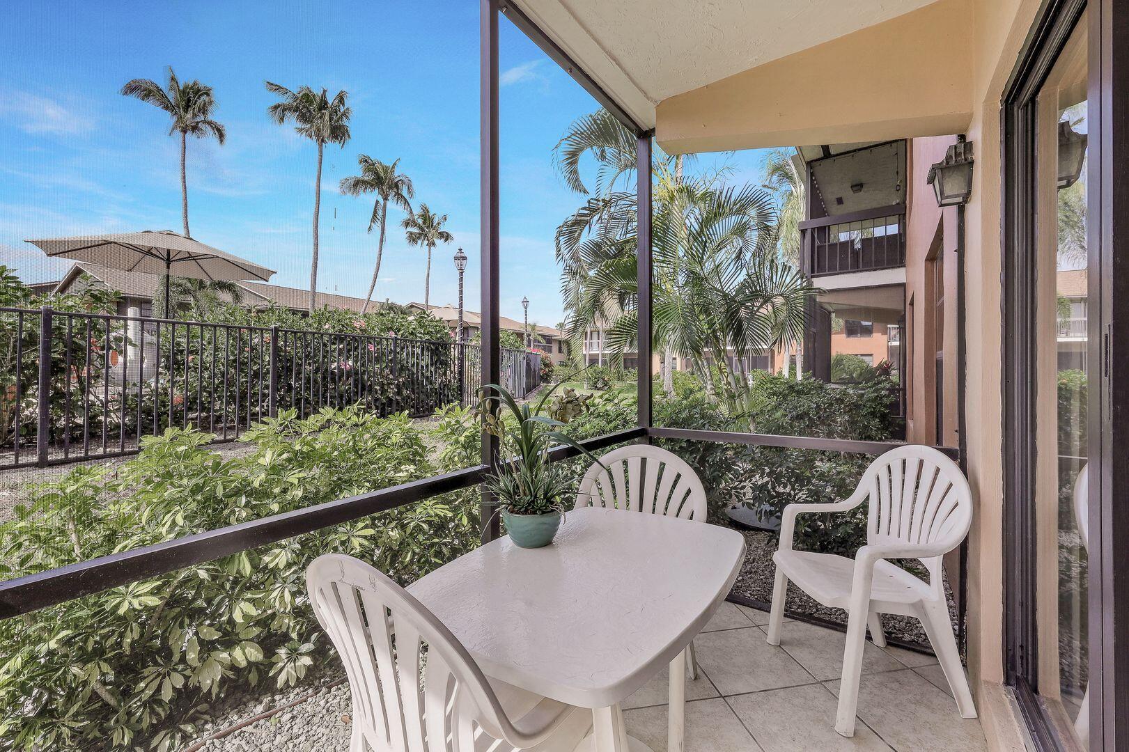 a view of a patio with table and chairs and potted plants