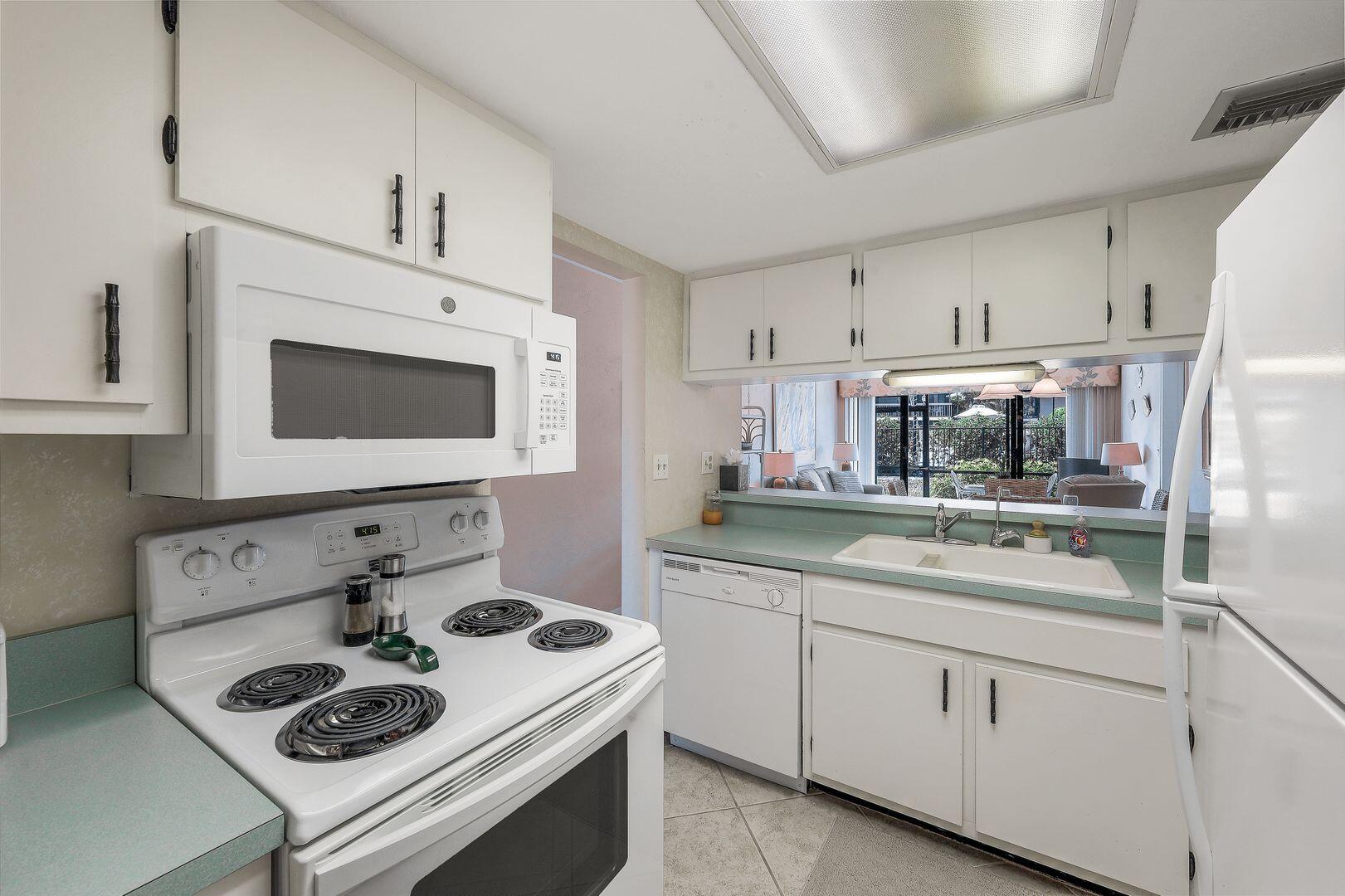 780 San Marco Road, Unit 104 Marco Island, FL 34145 - Photo 11 of 25 a kitchen with a sink a stove and cabinets