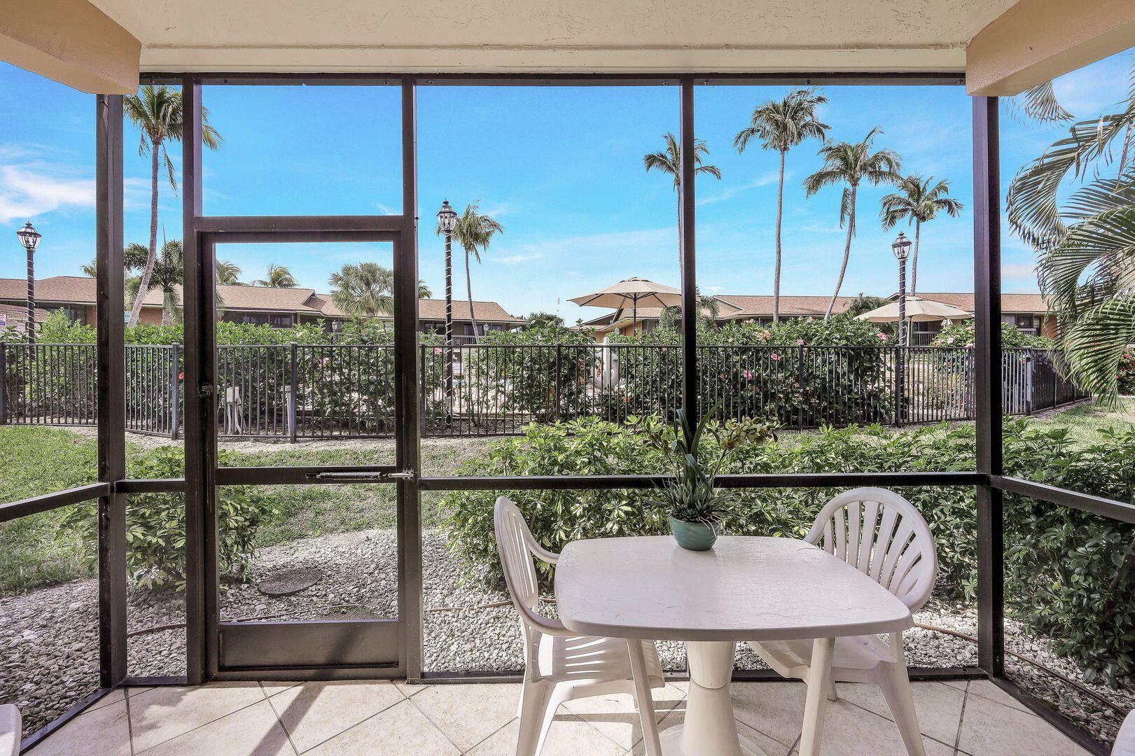 780 San Marco Road, Unit 104 Marco Island, FL 34145 - Photo 17 of 25 a view of a dining room with furniture large windows and wooden floor