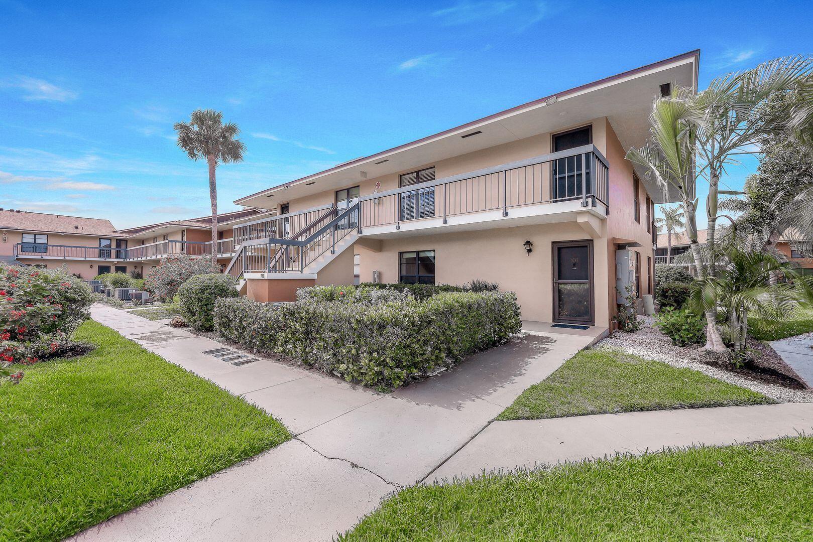 780 San Marco Road, Unit 104 Marco Island, FL 34145 - Photo 3 of 25 a front view of a house with garden