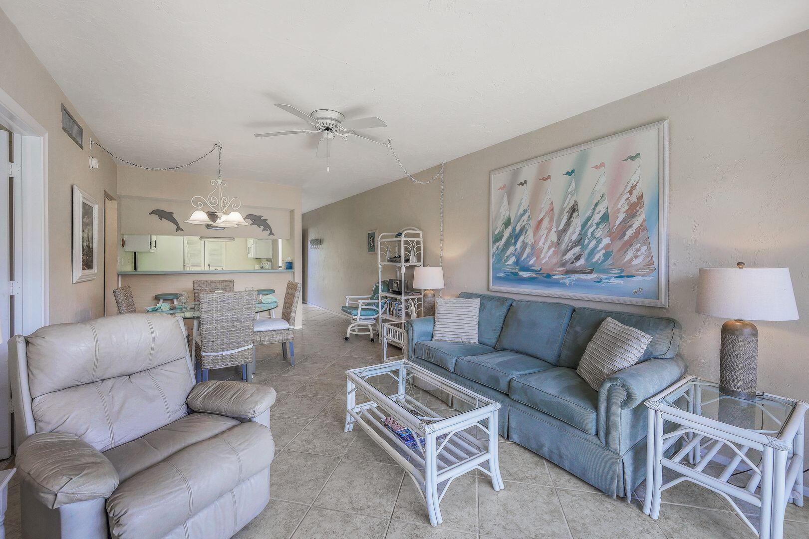 780 San Marco Road, Unit 104 Marco Island, FL 34145 - Photo 6 of 25 a living room with furniture and a painting