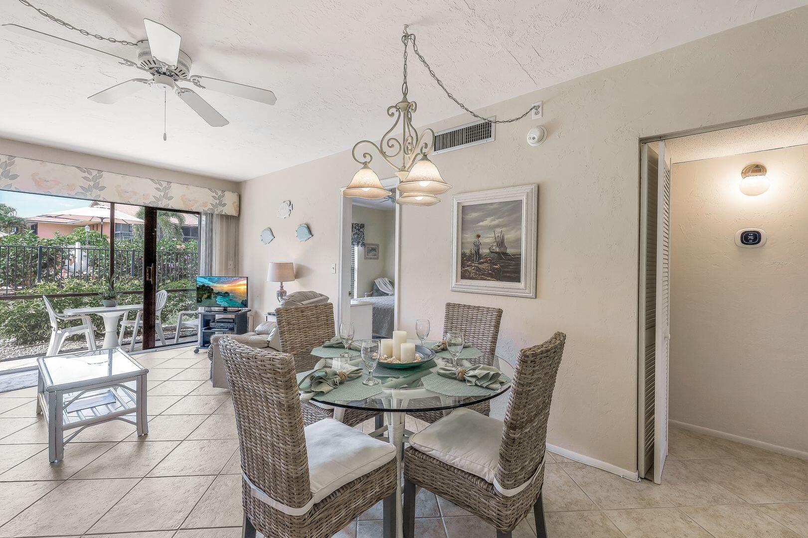 780 San Marco Road, Unit 104 Marco Island, FL 34145 - Photo 8 of 25 a dining room with furniture a chandelier and window