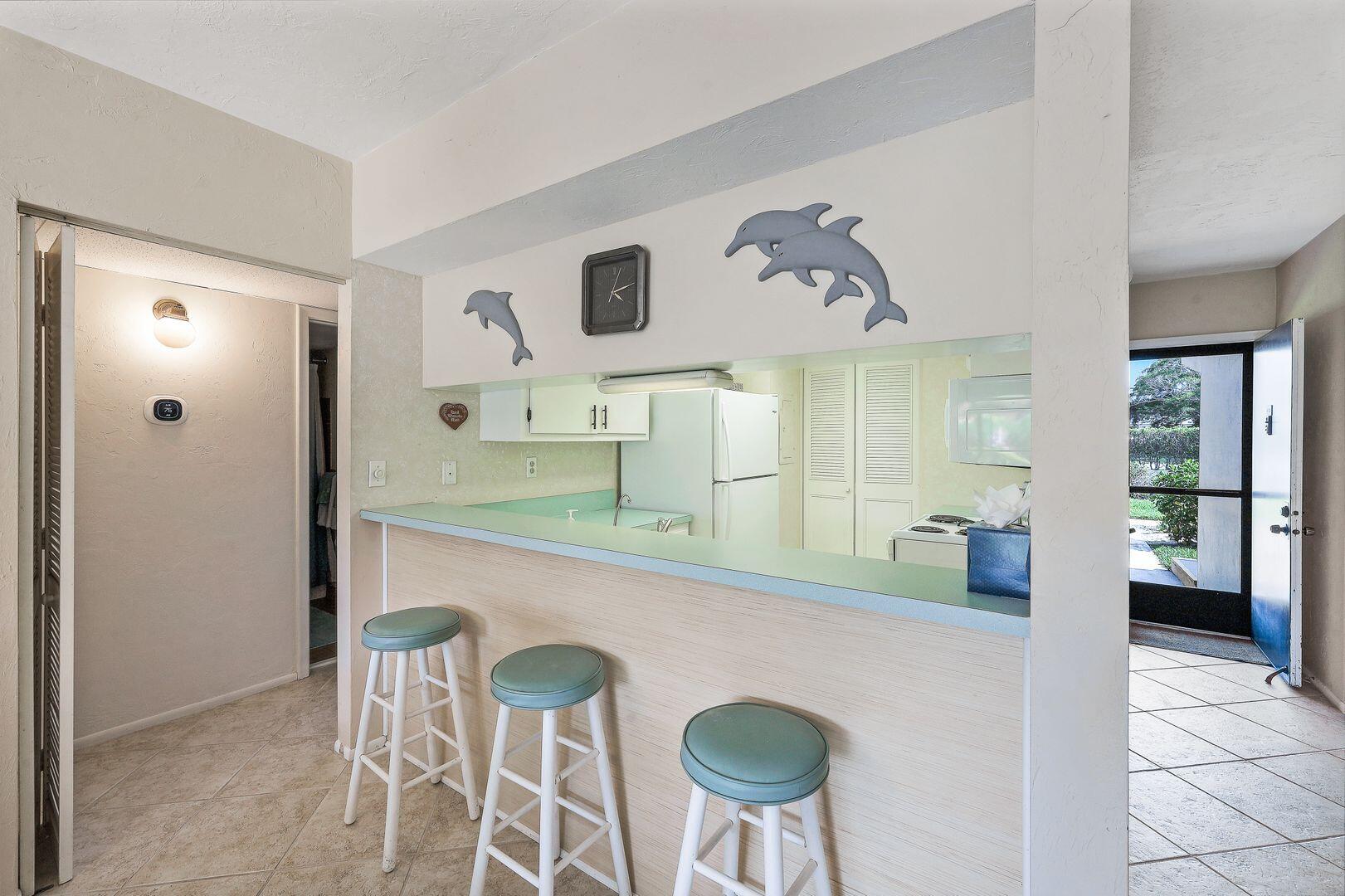 780 San Marco Road, Unit 104 Marco Island, FL 34145 - Photo 9 of 25 a kitchen with stainless steel appliances granite countertop a sink and a refrigerator