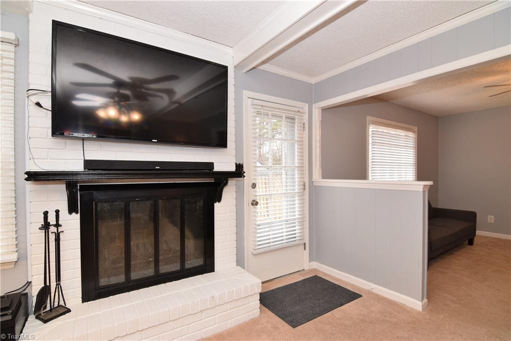 4300 Lormar Road Greensboro, NC 27406 - Photo 13 of 30 Cozy fireplace with a raised hearth.