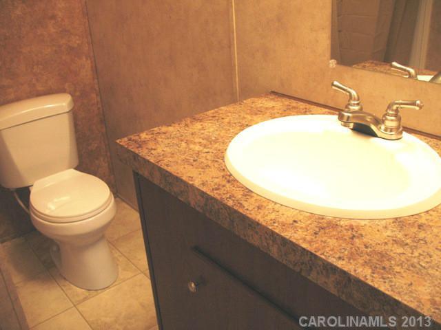 1638 Old Pinckney Road York, SC 29745 - Photo 13 of 16 a bathroom with a granite countertop sink and a toilet