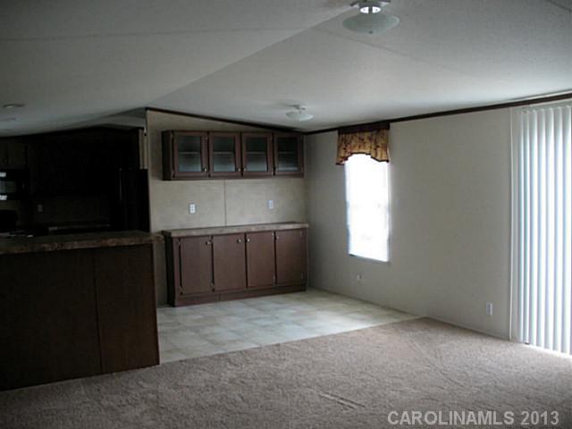 1638 Old Pinckney Road York, SC 29745 - Photo 16 of 16 a view of an empty room with a window and a kitchen