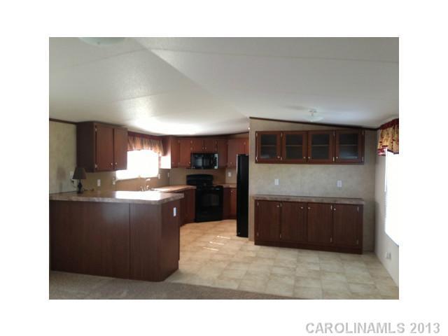 1638 Old Pinckney Road York, SC 29745 - Photo 3 of 16 a kitchen with stainless steel appliances granite countertop a refrigerator a stove and a sink
