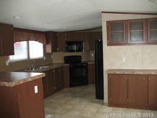 1638 Old Pinckney Road York, SC 29745 - Photo 7 of 16 a kitchen with granite countertop a sink stove and refrigerator