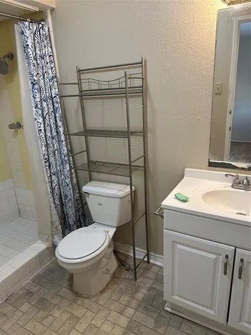 a white toilet sitting next to a bathroom sink