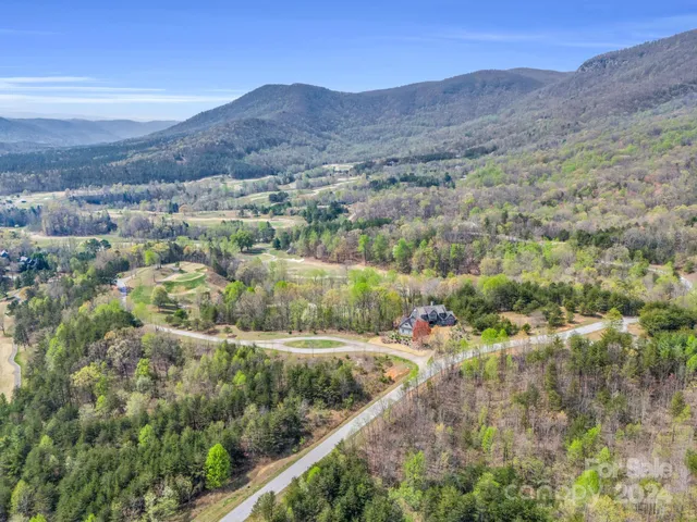 an aerial view of residential houses and outdoor space