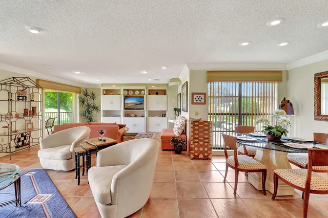 a living room with furniture and large windows