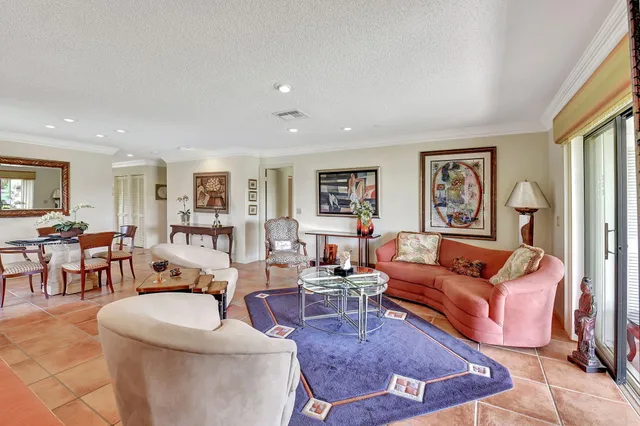 a living room with furniture fireplace and large window