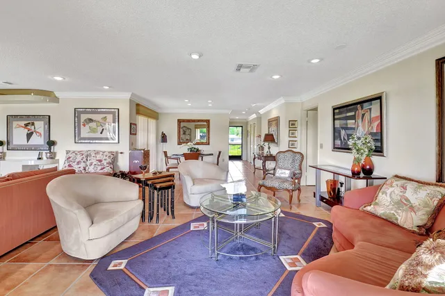 a living room with furniture and large windows