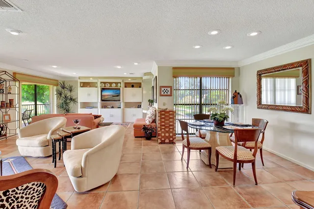 a living room with furniture ceiling fan and a rug