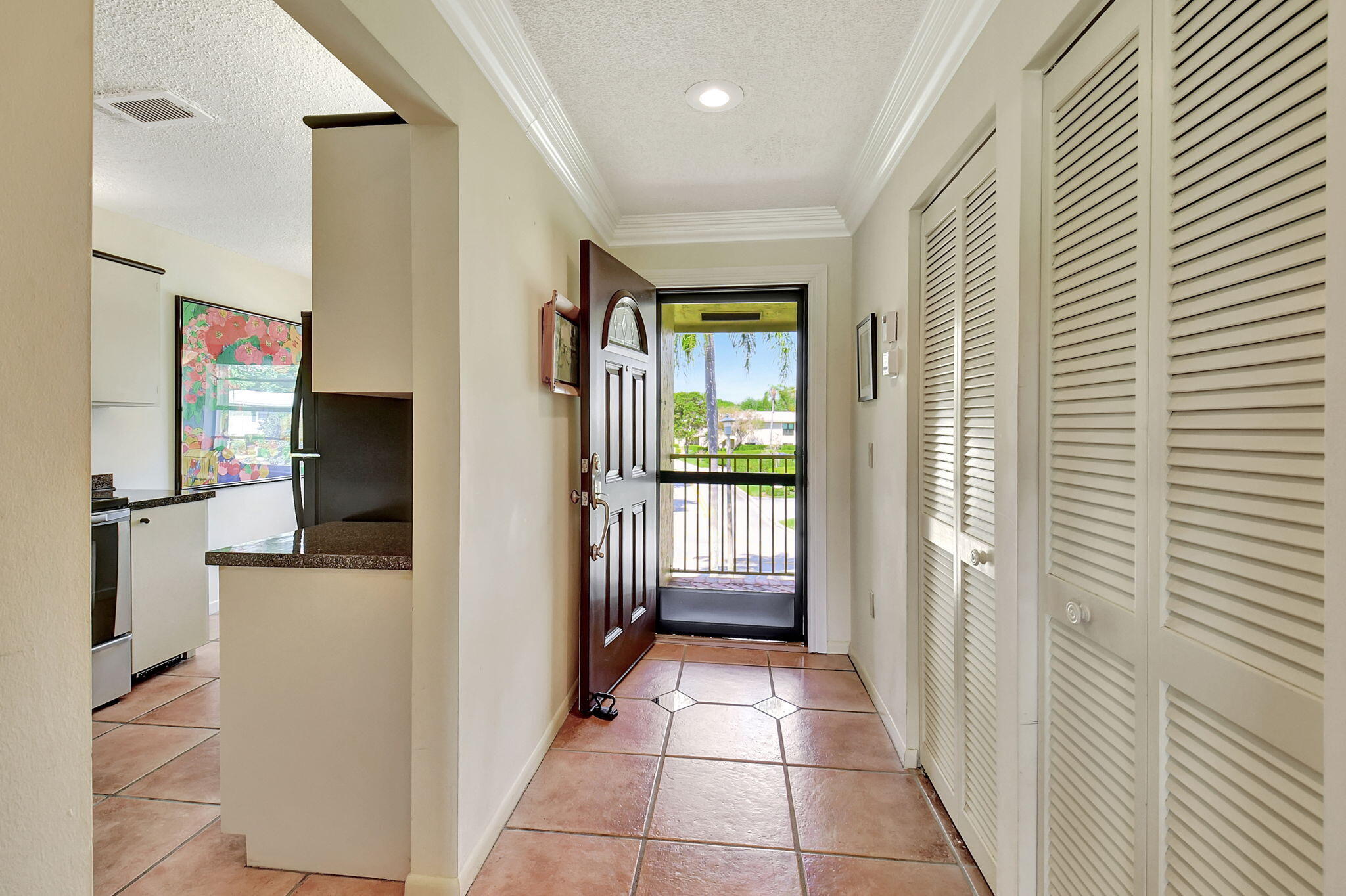 3 Stratford Drive, Unit H Boynton Beach, FL 33436 - Photo 3 of 81 a view of a hallway with a livingroom and a kitchen