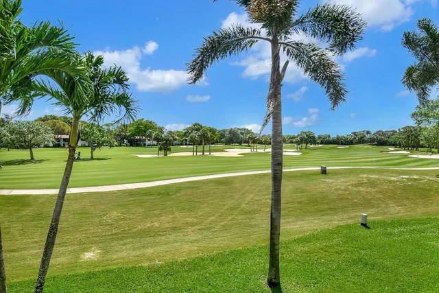 a living room with furniture kitchen view and a chandelier